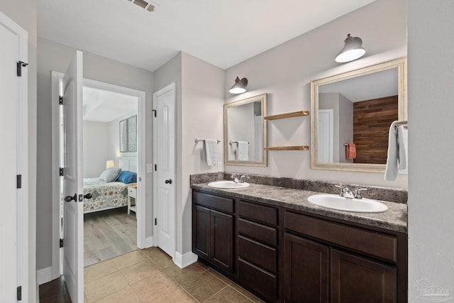 5613 Cane Syrup Cir, Pace, FL 32571 - bathroom with ensuite bathroom, double vanity, baseboards, and tile patterned flooring
