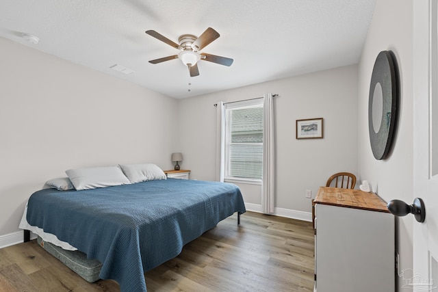 5613 Cane Syrup Cir, Pace, FL 32571 - bedroom with wood finished floors, baseboards, and ceiling fan