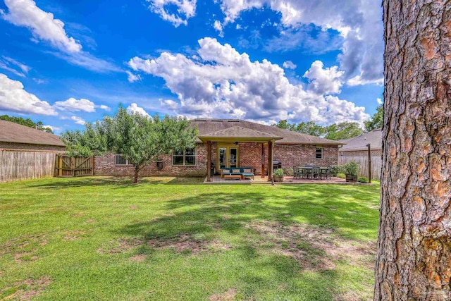 5613 Cane Syrup Cir, Pace, FL 32571 - back of house with a patio and brick siding