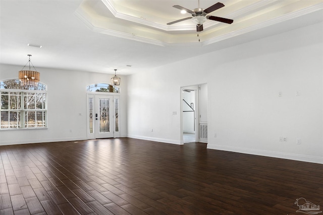 spare room featuring crown molding, dark hardwood / wood-style flooring, a raised ceiling, and ceiling fan with notable chandelier