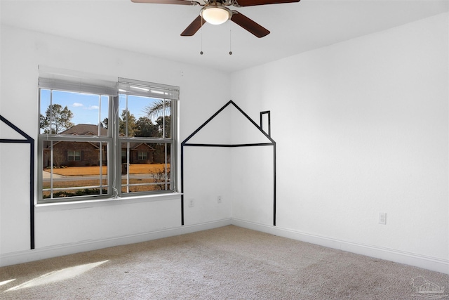 carpeted empty room featuring ceiling fan