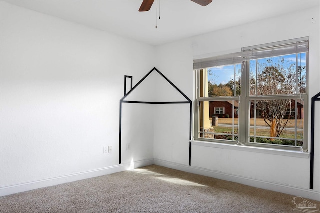 carpeted empty room featuring ceiling fan