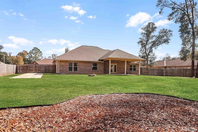 back of house featuring a yard and a patio