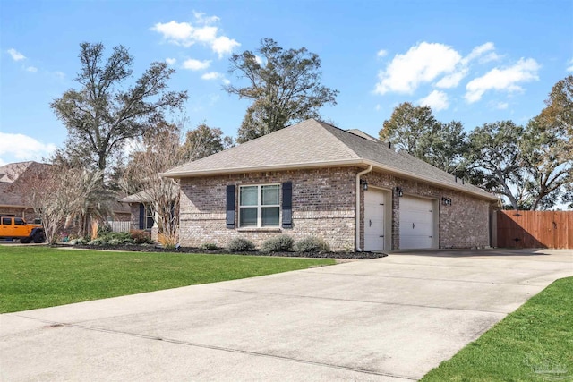 view of front of property featuring a garage and a front yard