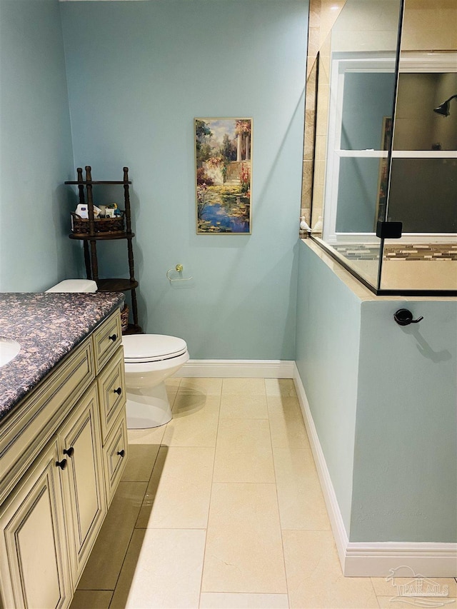 7453 Northpointe Blvd, Pensacola, FL 32514 - bathroom featuring vanity, walk in shower, toilet, tile patterned flooring, and baseboards