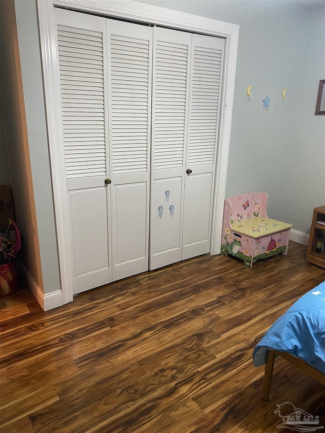 7453 Northpointe Blvd, Pensacola, FL 32514 - bedroom with wood finished floors, a closet, and baseboards