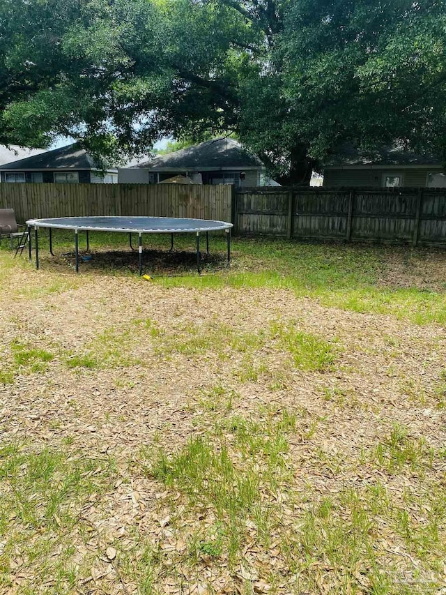 7453 Northpointe Blvd, Pensacola, FL 32514 - fenced backyard with a trampoline