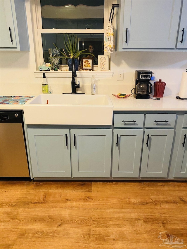 7453 Northpointe Blvd, Pensacola, FL 32514 - kitchen with stainless steel dishwasher, a sink, light countertops, and gray cabinetry