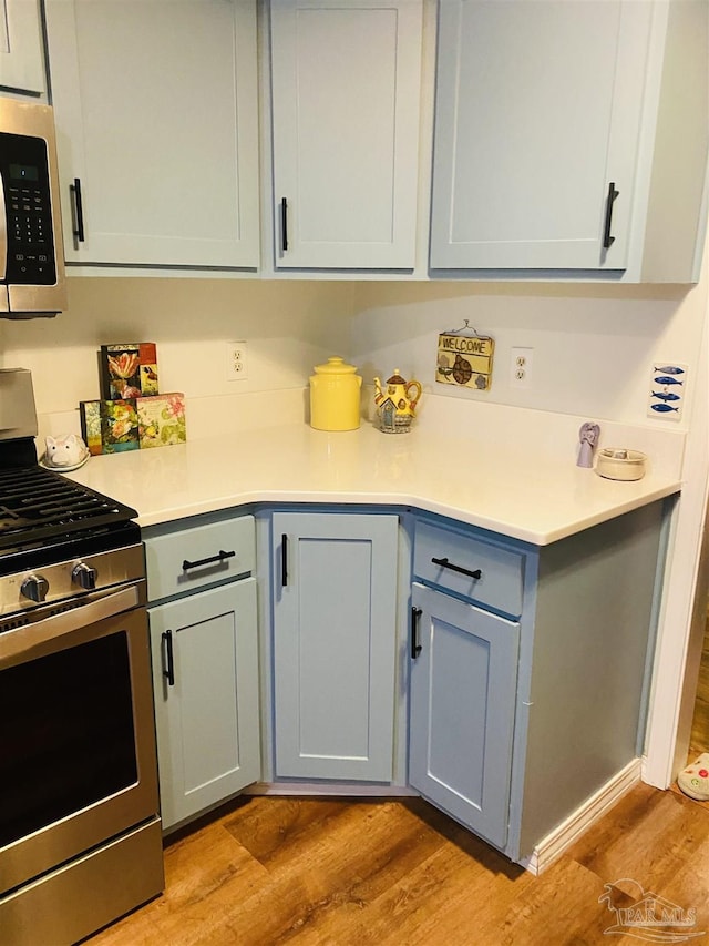 7453 Northpointe Blvd, Pensacola, FL 32514 - kitchen with appliances with stainless steel finishes, light wood finished floors, light countertops, and gray cabinetry