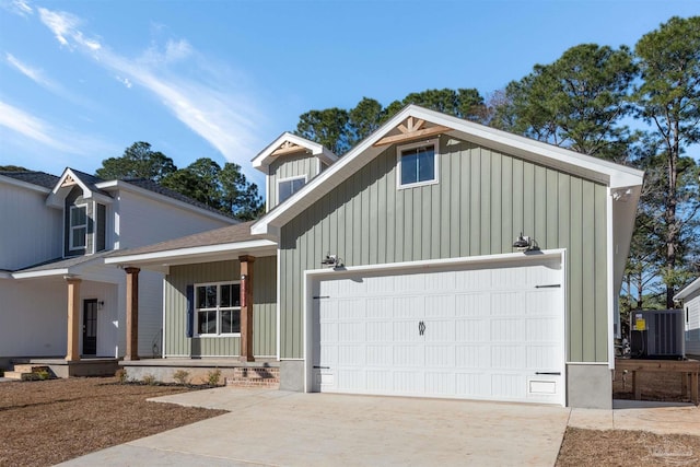 view of front of house featuring board and batten siding, concrete driveway, a garage, and central air condition unit