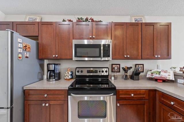 6742 Britt St, Navarre, FL 32566 - kitchen with stainless steel appliances, light countertops, and a textured ceiling