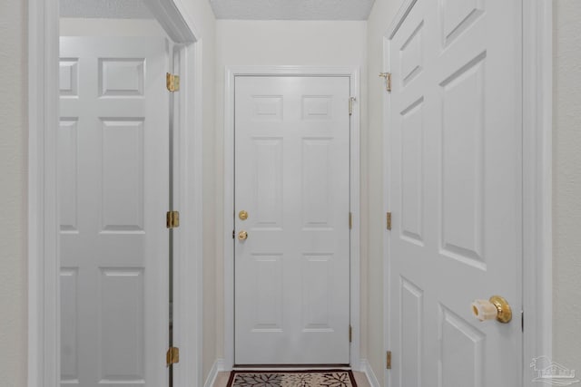 6742 Britt St, Navarre, FL 32566 - doorway to outside featuring a textured ceiling and baseboards