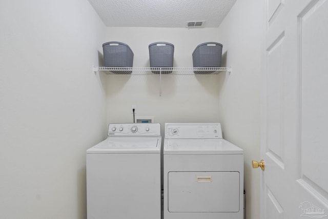 6742 Britt St, Navarre, FL 32566 - laundry area with washing machine and clothes dryer and a textured ceiling