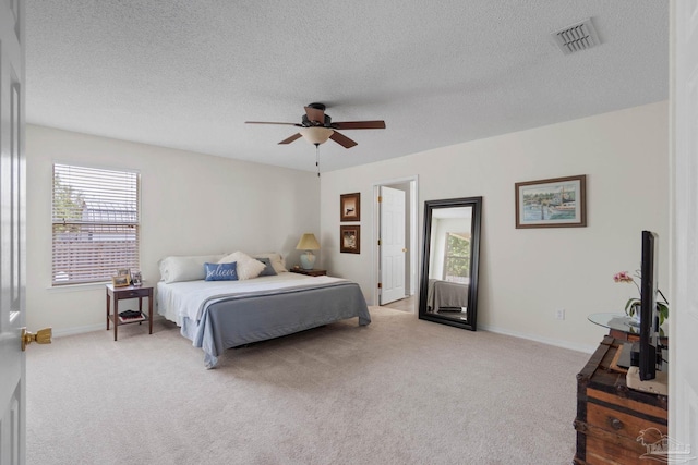 6742 Britt St, Navarre, FL 32566 - bedroom with multiple windows, light colored carpet, a textured ceiling, and a ceiling fan