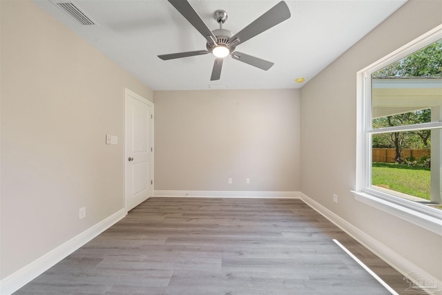 empty room featuring ceiling fan and light hardwood / wood-style floors