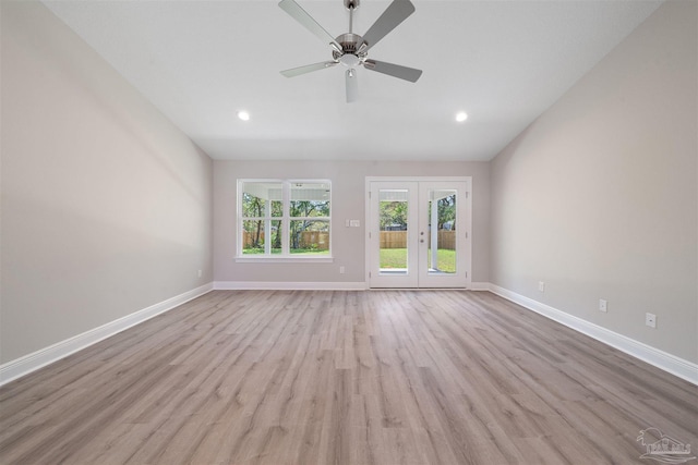 unfurnished living room with french doors, ceiling fan, and light hardwood / wood-style flooring