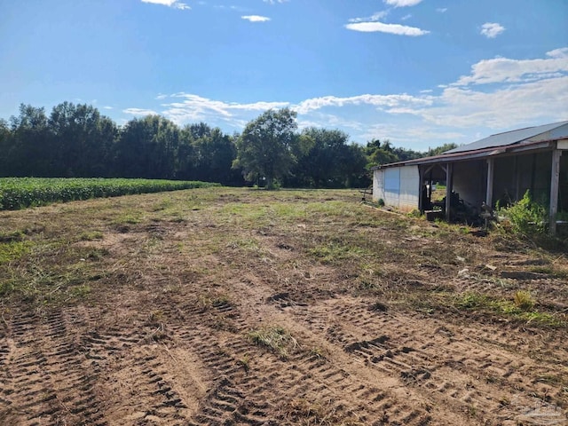 view of yard with a rural view and an outbuilding