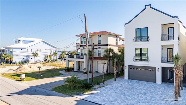 view of front of home with a balcony and a garage