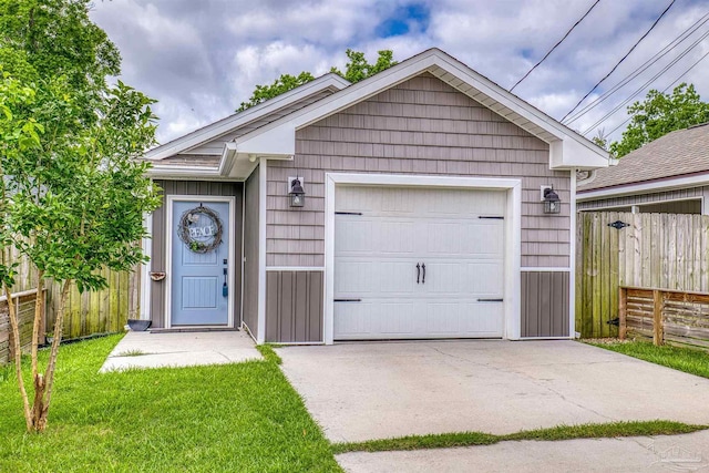 ranch-style house featuring fence, concrete driveway, an outbuilding, and a detached garage
