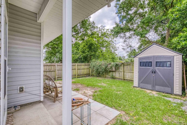 view of yard featuring a patio area, a shed, and an outdoor structure