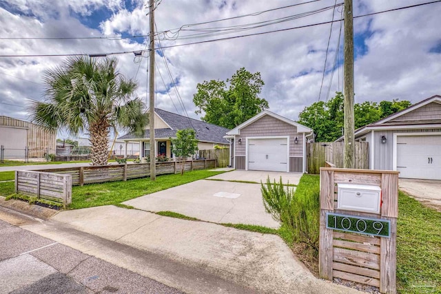 view of front of property with concrete driveway, a garage, and fence