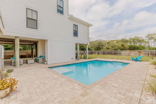 view of swimming pool featuring a patio, a fenced backyard, an outdoor living space, a fenced in pool, and a lawn