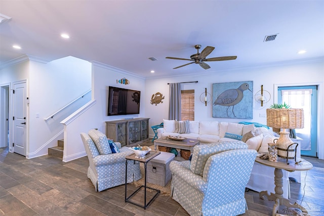 living room featuring a ceiling fan, visible vents, crown molding, stairway, and recessed lighting