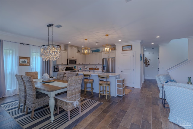 dining room featuring visible vents, crown molding, dark wood-style floors, an inviting chandelier, and recessed lighting