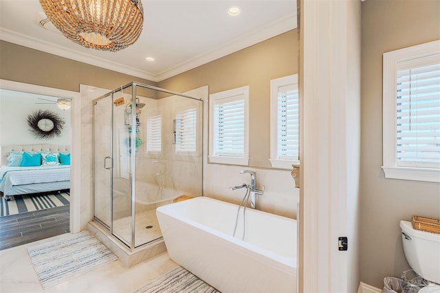 ensuite bathroom featuring a wealth of natural light, a soaking tub, and a stall shower