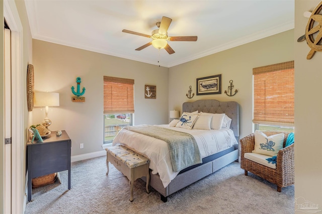 bedroom featuring crown molding, a ceiling fan, baseboards, and carpet