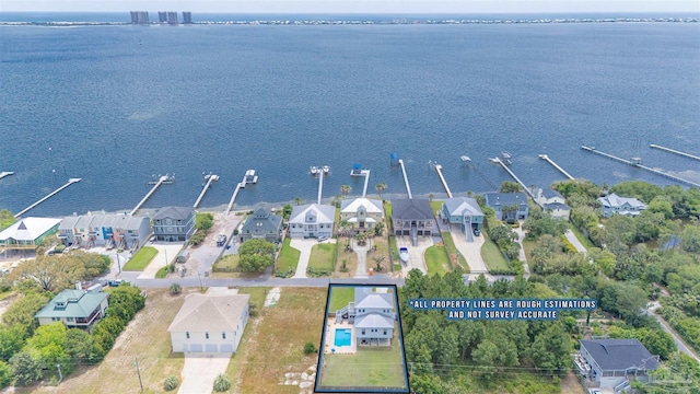 drone / aerial view featuring a water view and a residential view