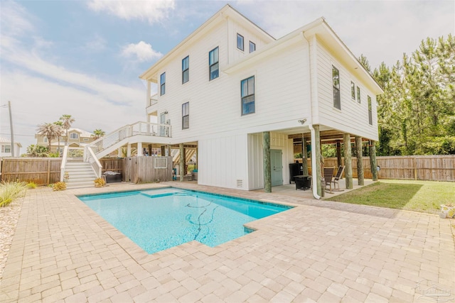 view of swimming pool featuring a fenced backyard, a fenced in pool, a patio, and stairway