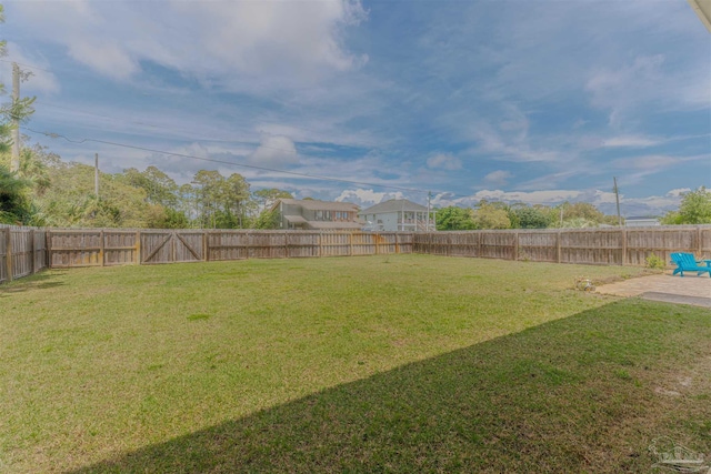 view of yard with a fenced backyard and a patio area