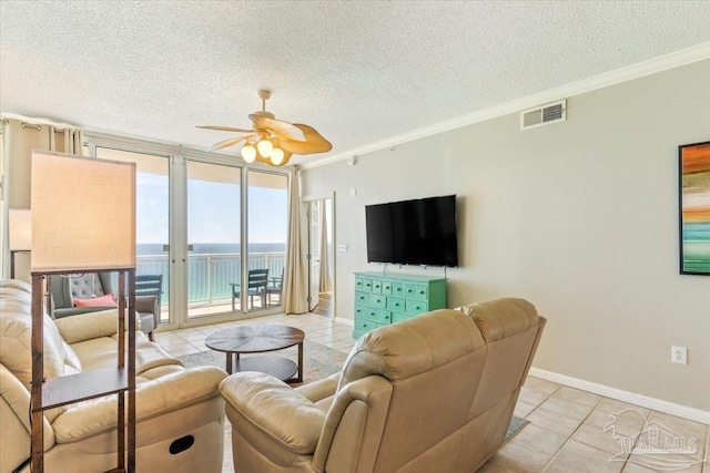 8499 Gulf Blvd Unit 1303, Navarre Beach, FL 32566 - living area featuring ornamental molding, light tile patterned flooring, a ceiling fan, a textured ceiling, and baseboards