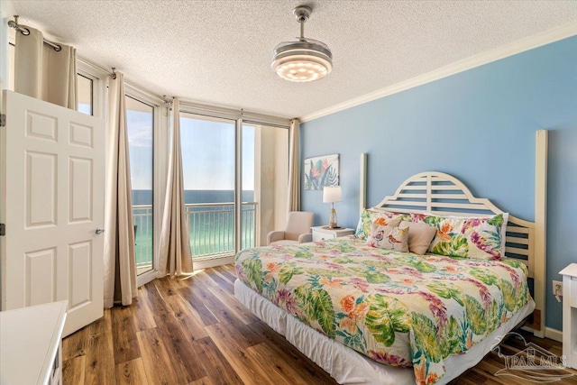 8499 Gulf Blvd Unit 1303, Navarre Beach, FL 32566 - bedroom with a textured ceiling, multiple windows, wood finished floors, crown molding, and access to exterior