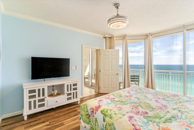 8499 Gulf Blvd Unit 1303, Navarre Beach, FL 32566 - bedroom featuring a textured ceiling, wood finished floors, access to outside, and crown molding