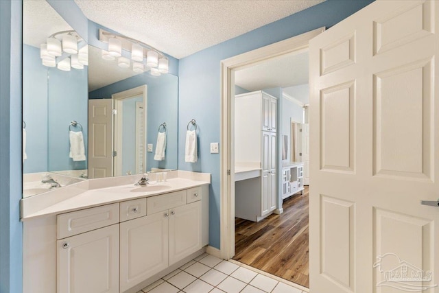 8499 Gulf Blvd Unit 1303, Navarre Beach, FL 32566 - bathroom with vanity, tile patterned floors, and a textured ceiling