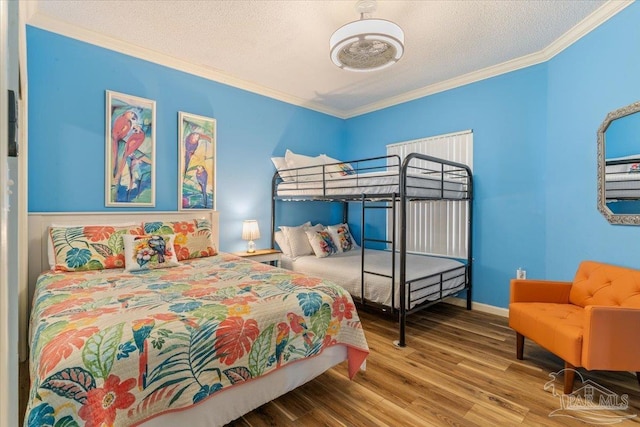 8499 Gulf Blvd Unit 1303, Navarre Beach, FL 32566 - bedroom with wood finished floors, ornamental molding, and a textured ceiling