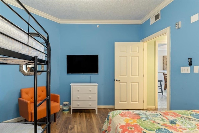 8499 Gulf Blvd Unit 1303, Navarre Beach, FL 32566 - bedroom with wood finished floors, ornamental molding, a textured ceiling, and baseboards
