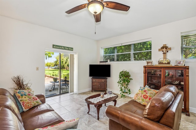 living room featuring light tile patterned flooring, ceiling fan, and plenty of natural light