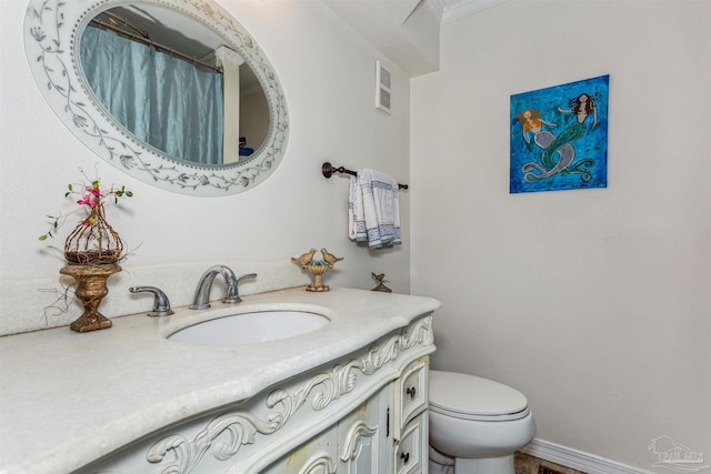 bathroom featuring vanity and toilet