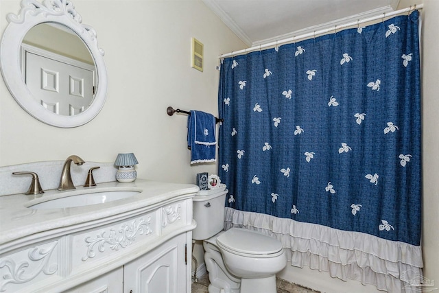 bathroom featuring vanity, crown molding, and toilet