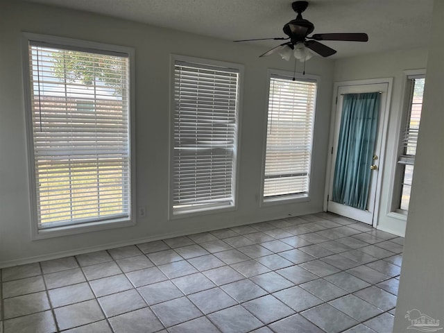 tiled empty room with ceiling fan