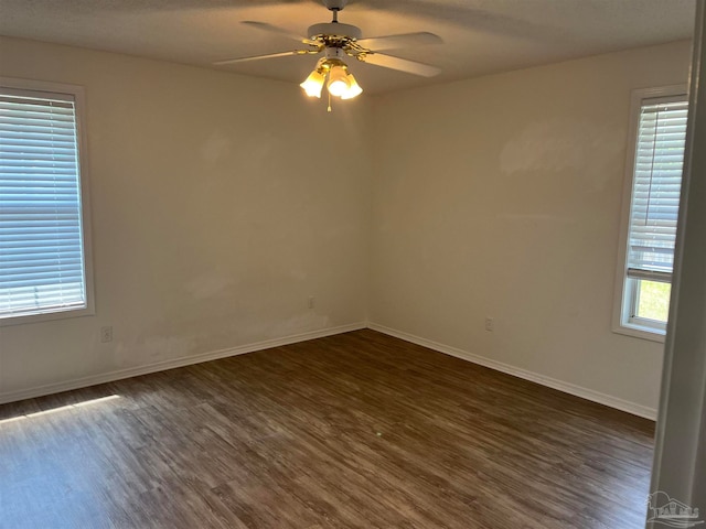 unfurnished room featuring dark hardwood / wood-style floors and ceiling fan