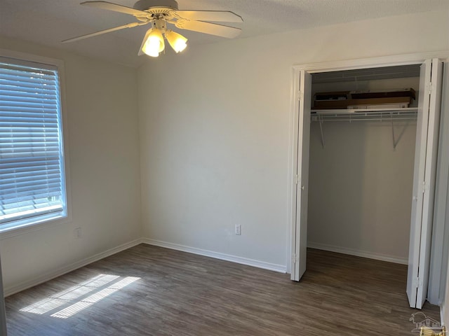 unfurnished bedroom featuring hardwood / wood-style flooring, a textured ceiling, a closet, and ceiling fan