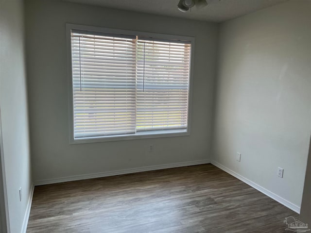 unfurnished room with plenty of natural light and hardwood / wood-style floors