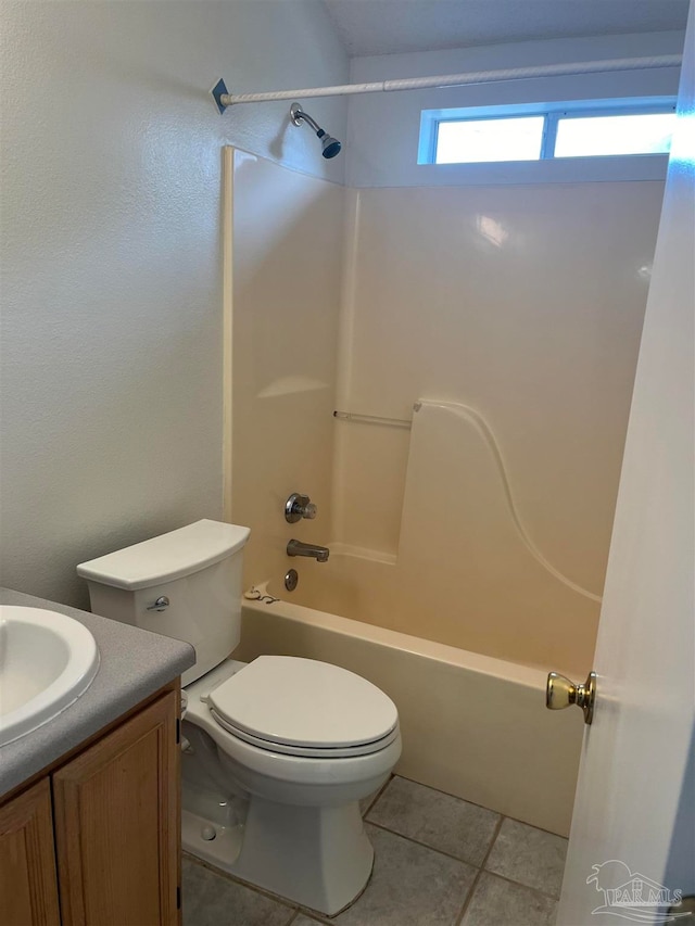 full bathroom featuring tile patterned flooring, bathtub / shower combination, toilet, and vanity