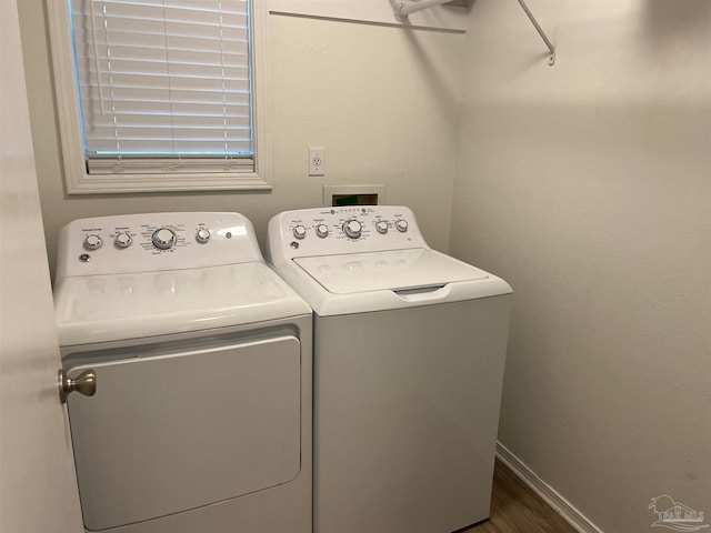 laundry area featuring dark hardwood / wood-style floors and washing machine and clothes dryer