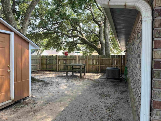 view of yard with a storage shed and central AC unit