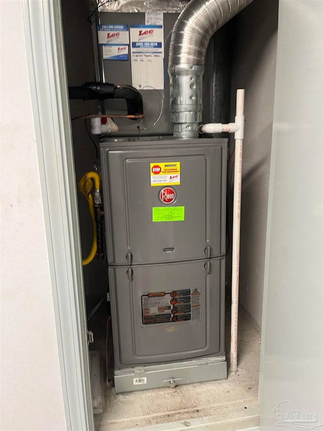 utility room featuring heating unit